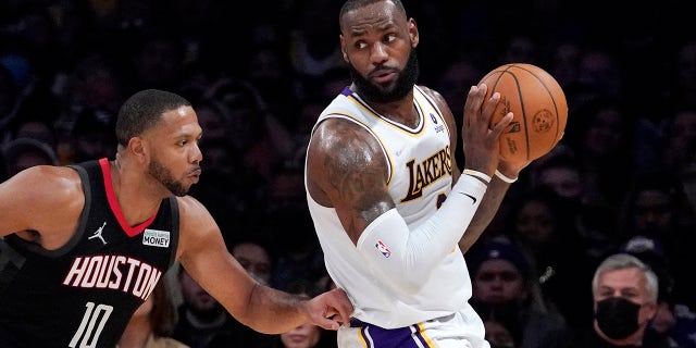 Los Angeles Lakers forward LeBron James, right, tries to move past Houston Rockets guard Eric Gordon during the second half of an NBA basketball game Sunday, Oct. 31, 2021, in Los Angeles.