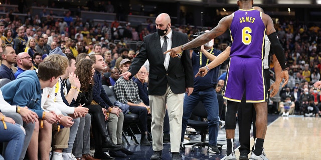 LeBron James of the Los Angeles Lakers points out fans that he had a disturbance with to security during the game against the Indiana Pacers on Nov 24, 2021, in Indianapolis.