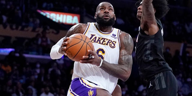 Los Angeles Lakers forward LeBron James, left, shoots as Houston Rockets guard Kevin Porter Jr. defends during a game Oct. 31, 2021, in Los Angeles.