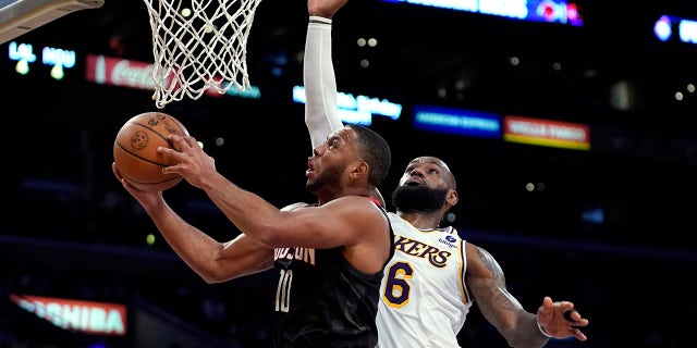 Houston Rockets guard Eric Gordon, left, shoots as Los Angeles Lakers forward LeBron James defends during the second half of an NBA basketball game Sunday, Oct. 31, 2021, in Los Angeles.