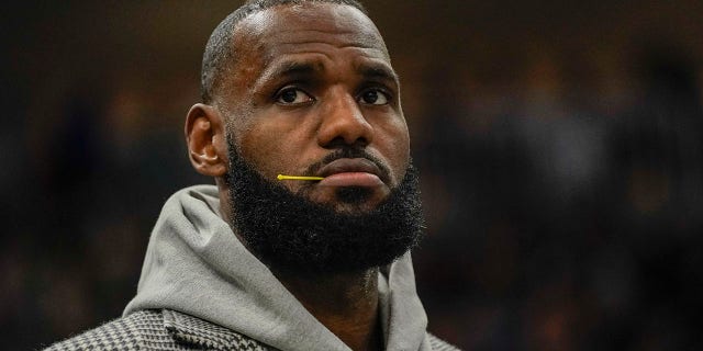 Los Angeles Lakers' LeBron James watches from the bench during the second half of an NBA basketball game against the Milwaukee Bucks Wednesday, Nov. 17, 2021, in Milwaukee. The Bucks won 109-102.