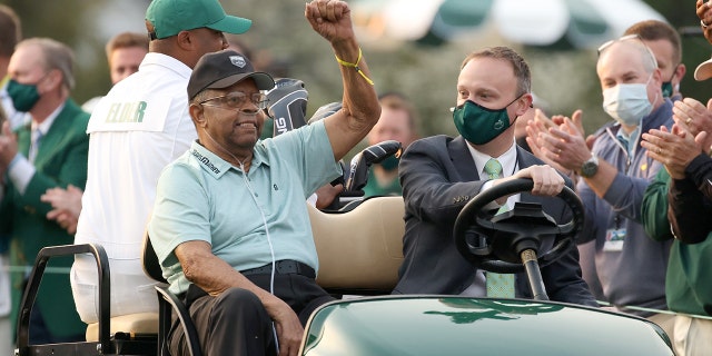 Honorary starter Lee Elder waves as he arrives to the opening ceremony of the Masters at Augusta National Golf Club on April 8, 2021, in Georgia.