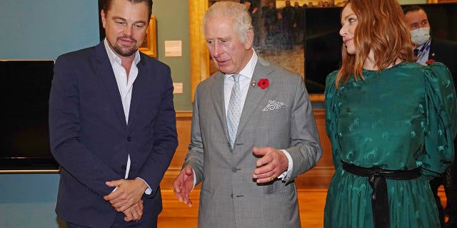 King Charles, former Prince of Wales, speaks with Leonardo DiCaprio as he views a fashion installation by designer Stella McCartney, at the Kelvingrove Art Gallery and Museum, during the Cop26 summit being held at the Scottish Event Campus on Nov. 3, 2021 in Glasgow, Scotland.