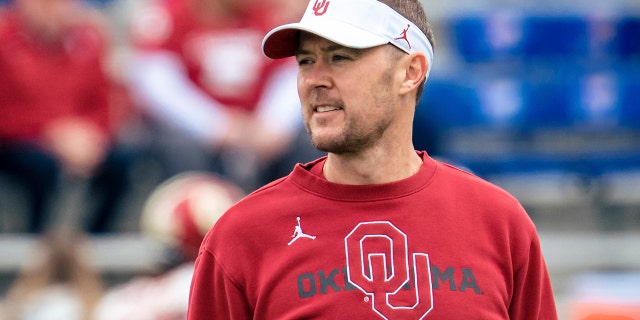 Lincoln Riley talks to his players before taking on the Kansas Jayhawks on Oct. 23, 2021, in Lawrence, Kansas.