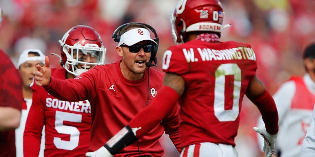 Lincoln Riley congratulates cornerback Woodi Washington after a fumble return for a touchdown against the Iowa State Cyclones on Nov. 20, 2021, in Norman, Oklahoma.