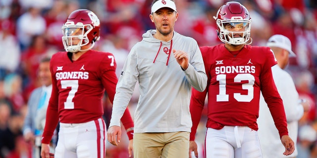 NORMAN, OK - OCTOBER 16: Head coach Lincoln Riley works with quarterback Spencer Rattler #7 and quarterback Caleb Williams #13 of the Oklahoma Sooners before a game against the Texas Christian University Horned Frogs at Gaylord Family Oklahoma Memorial Stadium on October 16, 2021 in Norman, Oklahoma. Oklahoma won 52-31.