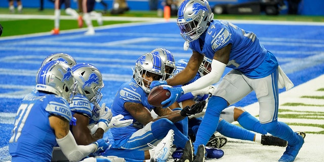 Detroit Lions cornerback Amani Oruwariye, right, celebrates his interception with teammates during the first half of an NFL football game against the Chicago Bears, Thursday, Nov. 25, 2021, in Detroit.