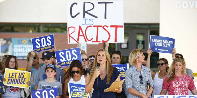 Amy Carney speaks on behalf of parents during a protest against critical race theory being taught at Scottsdale Unified School District before a digital school board meeting at Coronado High Schoo in Scottsdale on May 24, 2021.