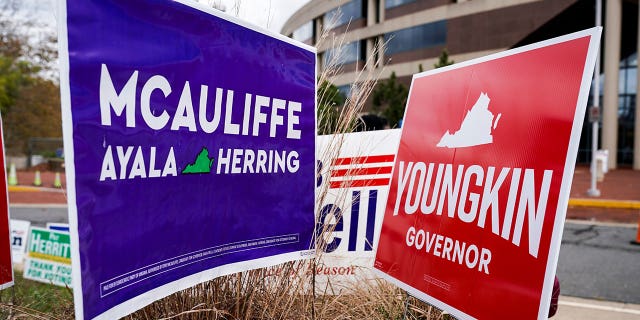 Campaign signs for Democrat Terry McAuliffe and Republican Glenn Youngkin stand together on the last day of early voting in the Virginia gubernatorial election in Fairfax, Virginia, on October 30, 2021.
