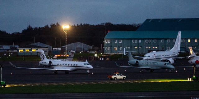 Jeff Bezos's private jet (left) pictured at a Glasgow airport ahead of the 2021 United Nations Climate Change Conference