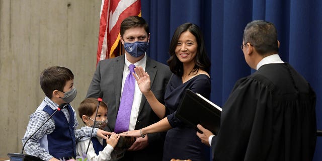 Surrounded by her family, Michelle Wu raises her right hand as she is sworn-in as Mayor by Judge Myong J. Joun, becoming the first woman and first person of color elected to the post, in Boston, Massachusetts, U.S., November 16, 2021.