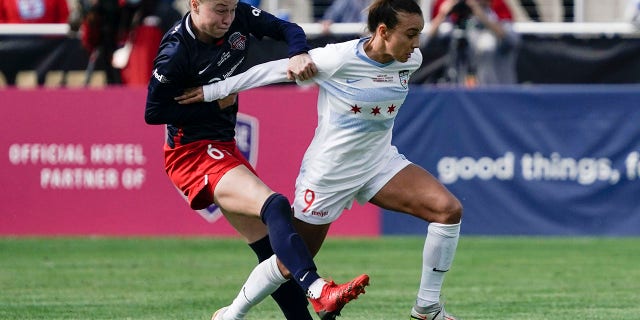 Chicago Red Stars forward Mallory Pugh (9) and Washington Spirit defender Emily Sonnett (6) fight for the ball during the first half of the NWSL Championship soccer match Saturday, Nov. 20, 2021, in Louisville, Ky.
