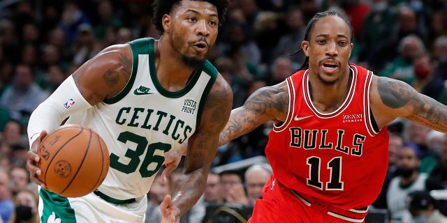 Boston Celtics' Marcus Smart (36) drives past Chicago Bulls' DeMar DeRozan (11) during the second half of an NBA basketball game, Monday, Nov. 1, 2021, in Boston.