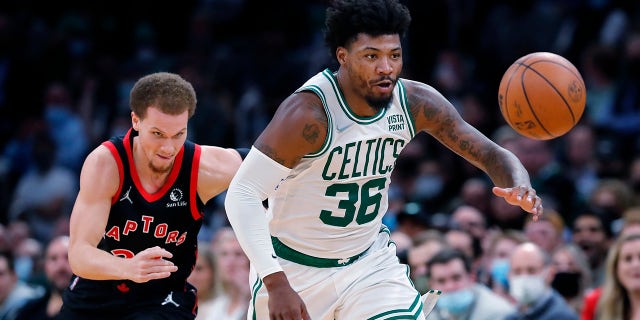 Boston Celtics' Marcus Smart (36) chases a loose ball in front of Toronto Raptors' Malachi Flynn during the first half of an NBA basketball game Wednesday, Nov. 10, 2021, in Boston.