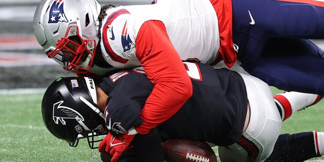 Matt Ryan of the Atlanta Falcons is sacked by Matt Judon of the New England Patriots in the second quarter at Mercedes-Benz Stadium on Nov. 18, 2021, in Atlanta, Georgia.