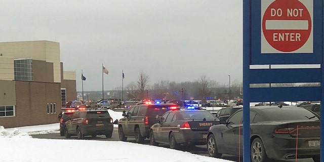 十一月 30, 2021; 牛津, 我, 美国; Police cars line up in front of the school following an active shooter situation at Oxford High School in Oxford on November 30, 2021. Police took a suspected shooter into custody and there were multiple victims, between four and six, the Oakland County Sheriff's office said, but no fatalities. Mandatory Credit: Liz Shepard-USA TODAY NETWORK