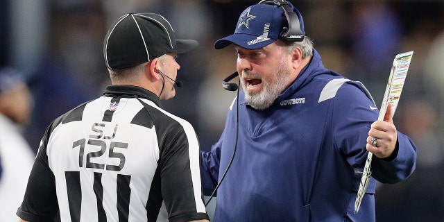 Head Coach Mike McCarthy of the Dallas Cowboys disputes a penalty with side judge Laird Hayes in overtime of the NFL match between the Las Vegas Raiders and Dallas Cowboys at AT&T Stadium on Nov. 25, 2021, in Arlington, Texas.
