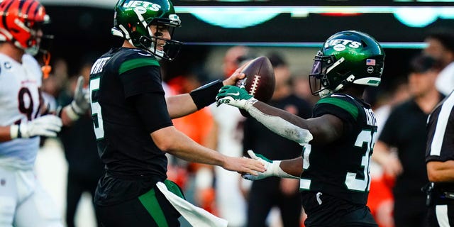 New York Jets quarterback Mike White, left, and Michael Carter celebrate after an NFL football game against the Cincinnati Bengals, Sunday, Oct. 31, 2021, in East Rutherford, N.J.