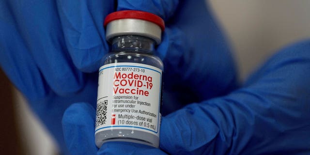 An employee shows the Moderna COVID-19 vaccine at Northwell Health's Long Island Jewish Valley Stream hospital in New York, U.S., December 21, 2020.