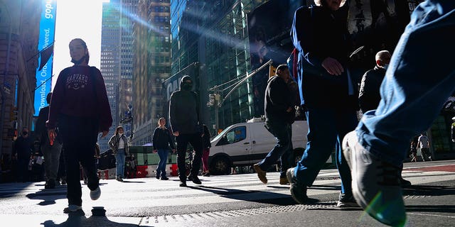 People walk though Times Square during the coronavirus disease (COVID-19) pandemic in the Manhattan borough of New York City, New York, U.S., November 10, 2021.