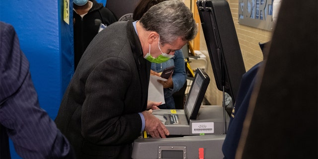 A Board of Election official opens the voting machine after Republican mayoral candidate Curtis Sliwa's ballot got stuck at a polling place on the Upper West Side on Nov. 2, 2021, in New York City.