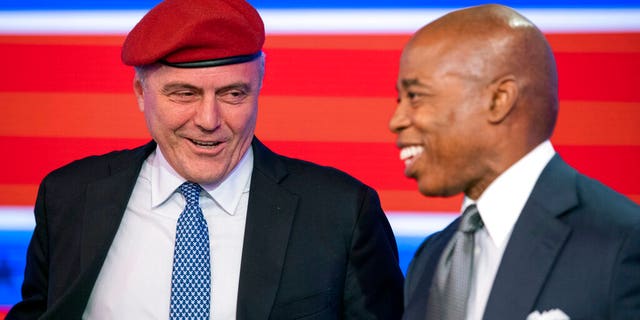 Then-Republican candidate for New York City mayor, Curtis Sliwa, left, and Eric Adams, the Democratic former NYPD captain who later won the election, smile after a debate at the ABC-7 studios in New York on Oct. 26, 2021.
