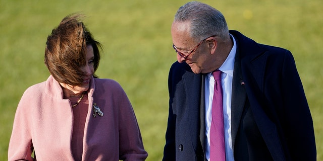 House Speaker Nancy Pelosi of Calif., and Senate Majority Leader Chuck Schumer of N.Y., talk before President Joe Biden signs the $1.2 trillion bipartisan infrastructure bill into law during a ceremony on the South Lawn of the White House in Washington, Monday, Nov. 15, 2021. (AP Photo/Susan Walsh)