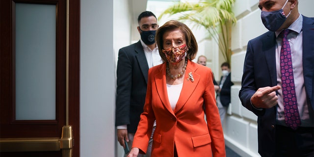 Speaker of the House Nancy Pelosi, D-Calif., arrives to meet with the Democratic Caucus at the Capitol in Washington, early Tuesday, Nov. 2, 2021. 