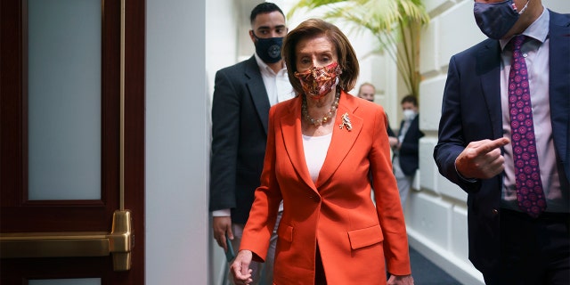 Speaker of the House Nancy Pelosi, D-Calif., arrives to meet with the Democratic Caucus at the Capitol in Washington, early Tuesday, Nov. 2, 2021. 