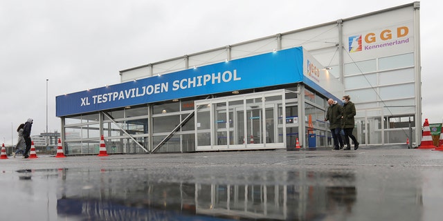 People walk outside XL Schiphol test pavilion after Dutch health authorities said that 61 people who arrived in Amsterdam on flights from South Africa tested positive for COVID-19, in Amsterdam, Netherlands, November 27, 2021.