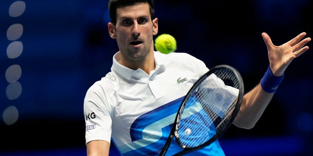 Novak Djokovic of Serbia returns the ball to Alexander Zverev of Germany during the ATP World Tour Finals in Turin, Italy, on Saturday, Nov. 20, 2021.