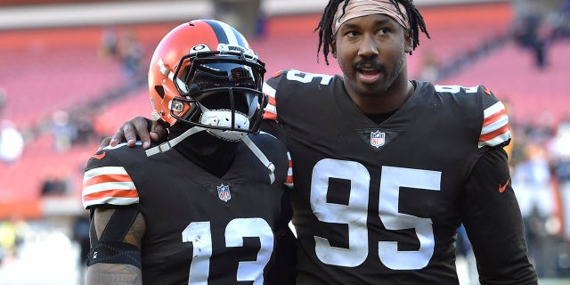 Cleveland Browns defensive end Myles Garrett (95) and wide receiver Odell Beckham Jr. (13) walk off the field after the Steelers defeated the Cleveland Browns 15-10 in an NFL football game, Sunday, Oct. 31, 2021, in Cleveland.