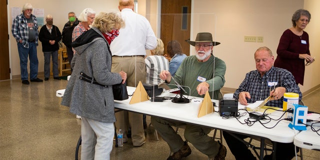 Voters cast their ballots at poling locations in Newark and Heath, Ohio, on Election Day on November 2, 2021.