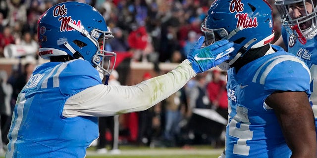 Mississippi wide receiver Jahcour Pearson (0) gives running back Snoop Conner (24) a tap after Conner scored a 13-yard touchdown during the second half of an NCAA college football game against Texas A&M, Saturday, Nov. 13, 2021, in Oxford, Miss. Mississippi won 29-19.
