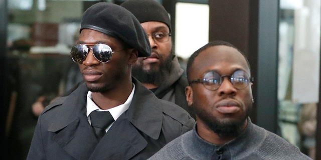 Brothers Olabinjo Osundairo, right, and Abimbola Osundairo, appear outside the Leighton Criminal Courthouse in Chicago, Feb. 24, 2020. 