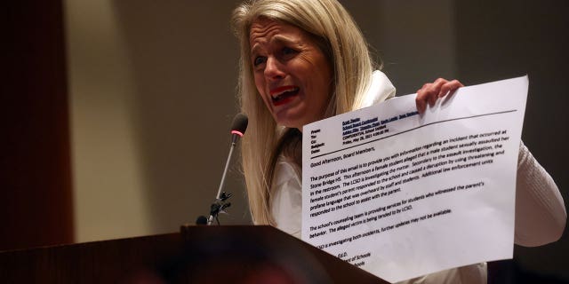 Heather Fruzzetti makes a public statement as people protest different issues including the board’s handling of a sexual assault that happened in a school bathroom in May, vaccine mandates and critical race theory during a Loudoun County School Board meeting in Ashburn, Virginia, U.S., October 26, 2021. Picture taken October 26, 2021.