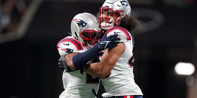 New England Patriots linebacker Jahlani Tavai (48) and New England Patriots safety Adrian Phillips (21) celebrate a defense of stop of the Atlanta Falcons during the second half of an NFL football game, Thursday, Nov. 18, 2021, in Atlanta.