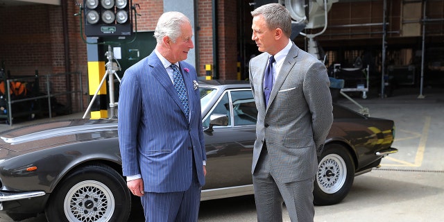 Prince Charles, Prince of Wales meets with actor Daniel Craig during a visit to the James Bond set at Pinewood Studios on June 20, 2019 in Iver Heath, England. The studio reportedly caught fire on Thursday night after residents reported hearing a 'very big explosion' followed by smoke.