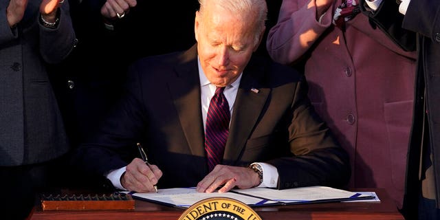 President Biden signs the "Infrastructure Investment and Jobs Act" during an event on the South Lawn of the White House, Monday, Nov. 15, 2021, in Washington. (AP Photo/Evan Vucci)