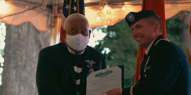 John Spencer Jr. given a Purple Heart, the Combat Infantryman Badge and the Republic of Vietnam Gallantry Cross at the University of North Carolina School of Law for his service. 