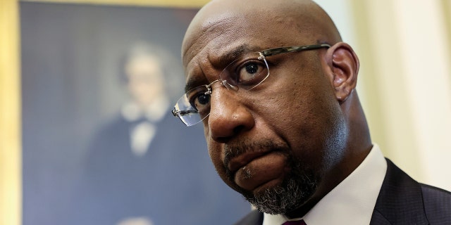 Sen. Raphael Warnock arrives for the Senate Democrats' weekly policy lunch at the U.S. Capitol on June 15, 2021.