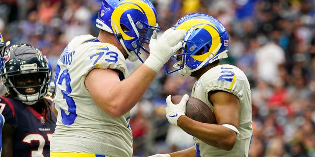 Los Angeles Rams wide receiver Robert Woods (2) celebrates his touchdown catch with teammate Los Angeles Rams offensive tackle David Edwards (73) during the first half of an NFL football game against the Houston Texans, Sunday, Oct. 31, 2021, in Houston.