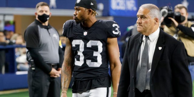 Las Vegas Raiders safety Roderic Teamer (33) leaves the field after being ejected following a fight that included Teamer and Dallas Cowboys' Kelvin Joseph in the second half of an NFL football game in Arlington, Texas, Thursday, Nov. 25, 2021. (AP Photo/Michael Ainsworth)