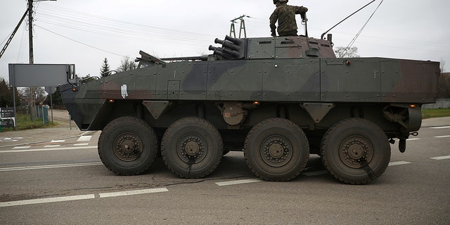 A Polish soldier rides a Rosomak Armored Personnel Carrier (APC) during migrant crisis on the Belarusian - Polish border, in Dubicze Cerkiewne, Poland November 15, 2021. REUTERS/Kacper Pempel