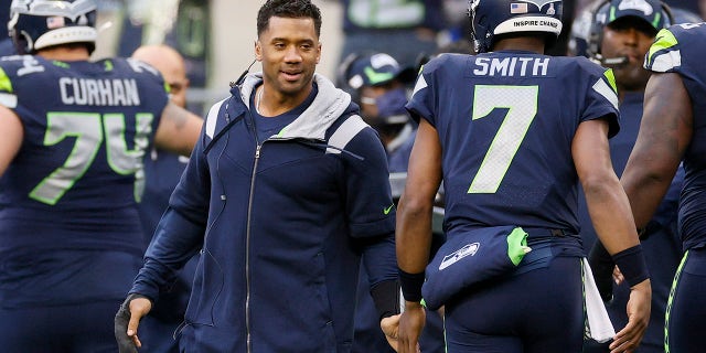 Geno Smith of the Seahawks is congratulated by Russell Wilson following a touchdown against the New Orleans Saints on Oct. 25, 2021, in Seattle, Washington.