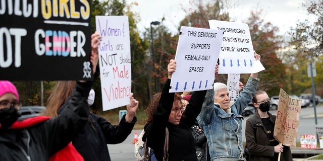 People gather to protest different issues including the board’s handling of a sexual assault that happened in a school bathroom in May, vaccine mandates and critical race theory during a Loudoun County School Board meeting in Ashburn, Virginia, U.S., Oct. 26, 2021.