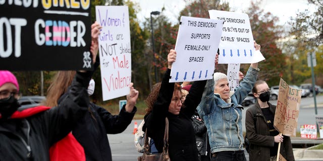 People gather to protest different issues including the board’s handling of a sexual assault that happened in a school bathroom in May, vaccine mandates and critical race theory during a Loudoun County School Board meeting in Ashburn, Virginia, U.S., Oct. 26, 2021.