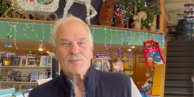 Norman Bruce, the owner of Martha Merrell's Books and Toys, opened his doors to frightened parade-goers after the assault.