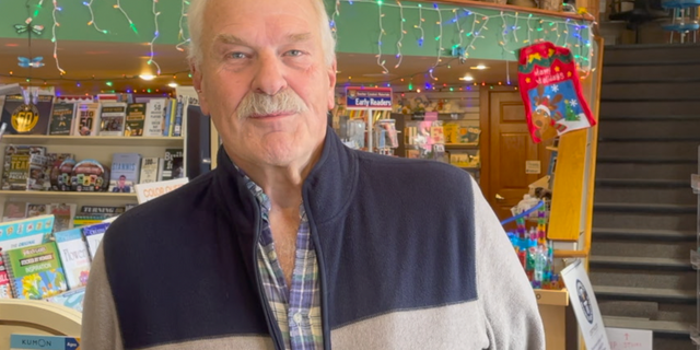 Norman Bruce, the owner of Martha Merrell's Books and Toys, opened his doors to frightened parade-goers after the assault.