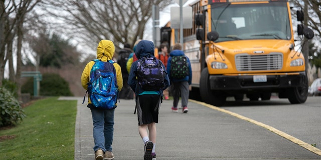 Students leave the Thurgood Marshall Elementary School after the Seattle Public School system was abruptly closed due to coronavirus fears on March 11, 2020, in Seattle.